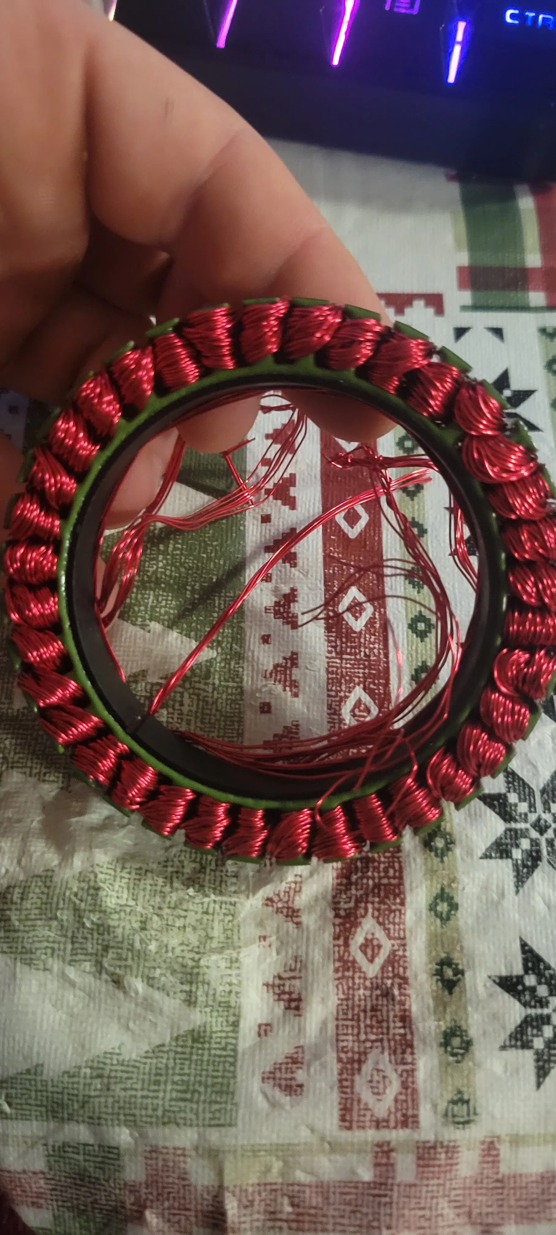 Close-up of the hand-wound stator showing red enamelled copper packed around the stator teeth