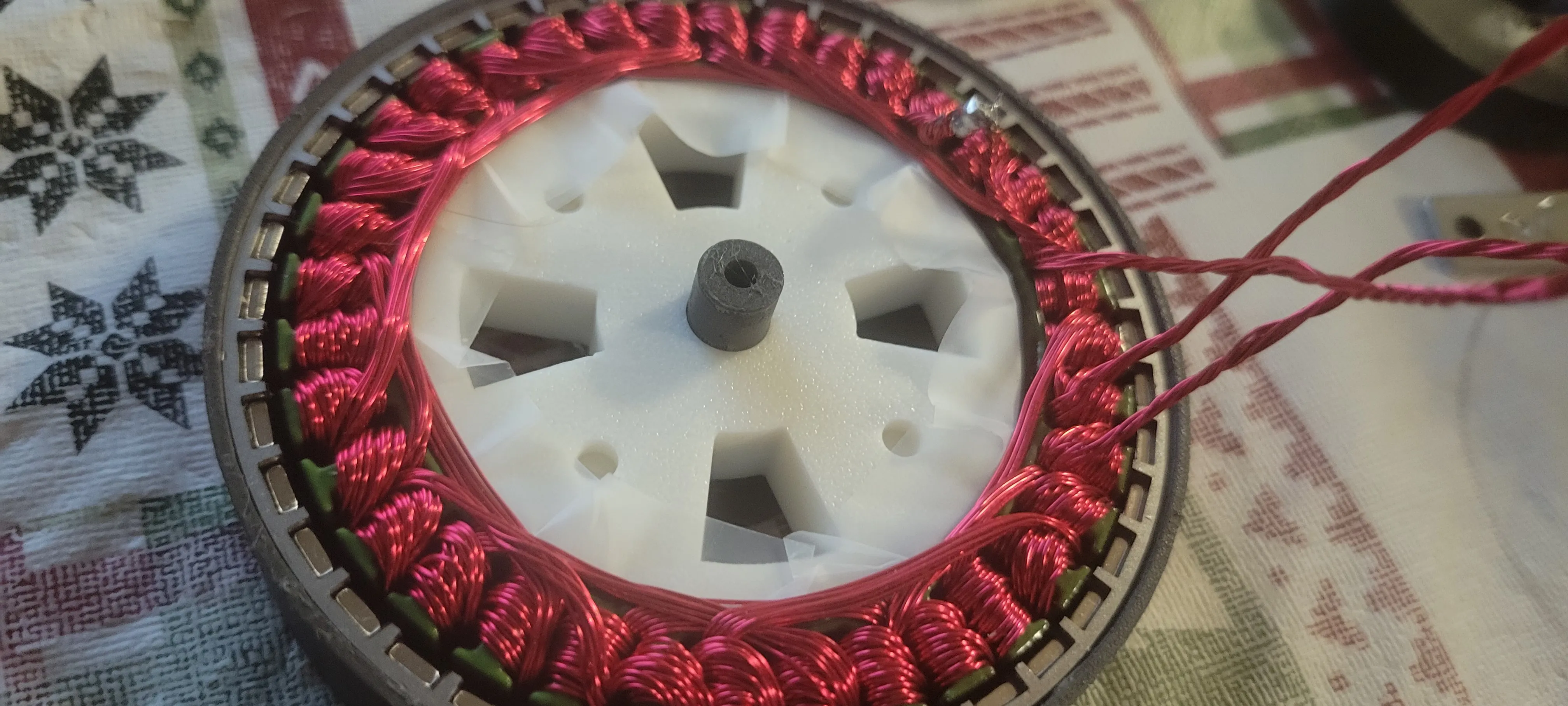 Hand-wound BLDC stator assembled around a white 3D-printed rotor carrier